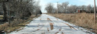 This dirt road, now SW 65 Road, leads past the old Shields place on the northwest edge of Pawnee Rock. Copyright 2006 Leon Unruh.
