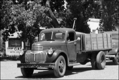 A detail from one of Paul Schmidt's photos of wheat trucks lined up on Central Street in the early 1950s. Photo copyright 2010 by Paul Schmidt.