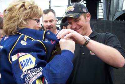 Clint Bowyer autographs a jacket for Julie McFann. Photo sent by June McFann.