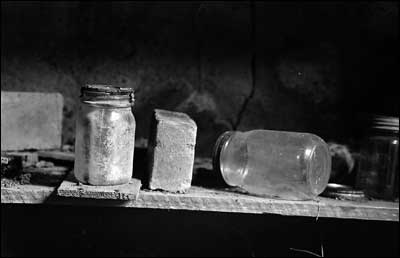 Jars and bricks on a shelf in the backyard cellar of the Otis and Lena Unruh farm. Photo copyright 2009 by Leon Unruh.