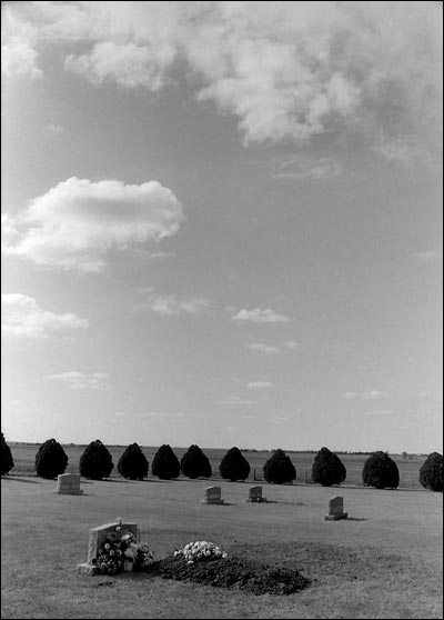 Fresh grave of Lena Unruh, May 1990, Mennonite Memorial Cemetery north of Pawnee Rock. Photo copyright 2010 by Leon Unruh.