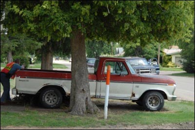 A Barton County sheriff's deputy aims his pistol at a man driving an SUV in Pawnee Rock as the search began Saturday for Jeffrey Chapman. The driver was not Chapman. Jim Dye made this photo. Photo copyright 2010 by Jim Dye.