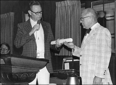 John Foster makes a presentation at a Lions Club event at the Harvest Inn in Larned in 1974 or 1975. Photo copyright 1975 by Leon Unruh.