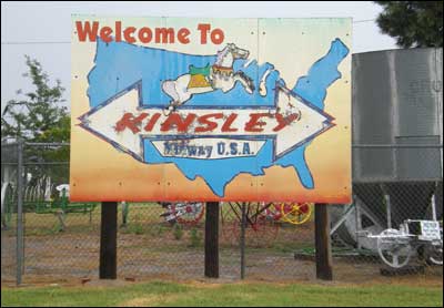 Sign showing that Kinsley, Kansas, is halfway between the Pacific and Atlantic coasts. Photo copyright 2010 by Leon Unruh.