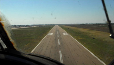 The C-45 drives down to the runway at the Great Bend airport. The hangars are to the east. Photo copyright 2010 by Jim Dye.