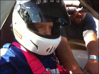 Nik gets strapped into the 07 Bandolero. Photo copyright 2010 by Leon Unruh.