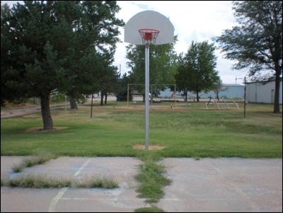 The Pawnee Rock basketball court in the city park awaits players on a summer evening. Photo copyright 2010 by Leon Unruh.