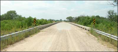 The road across the Pawnee Rock bridge is straighter than before this version was built. Photo copyright 2006 by Leon Unruh.