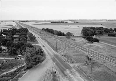 This is a photo I made of east Pawnee Rock in 1974. It shows the cattle-pen area that Carl Munger writes about -- the cluster of trees in the middle foreground on the right, between the tracks and Janell Avenue. Photo copyright 2012 by Leon Unruh.