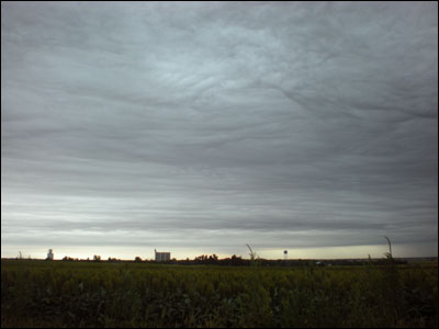 The storm's leading clouds move over Pawnee Rock, as viewed from the cemetery. Photo copyright 2010 by Leon Unruh.