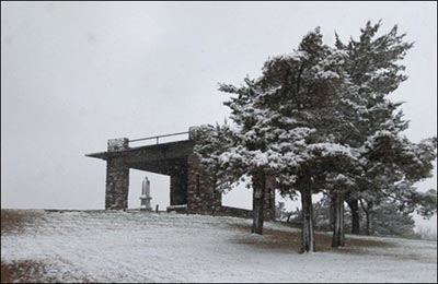 The Pawnee Rock State Park monument, viewed through the pavilion. Photo copyright 2011 by Jim Dye.