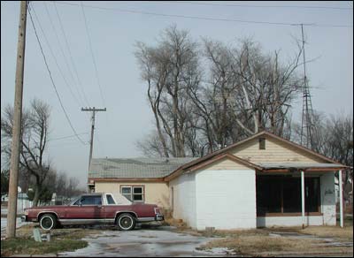 Home that once housed Schmidt Television and Radio. In this 2005 view, the old windmill tower is still visible out back; it's perfectly used now as a tower for a television antenna. Photo copyright 2009 by Leon Unruh.