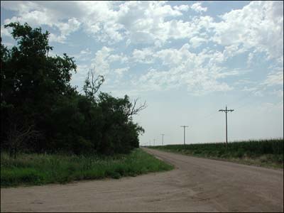 The shelterbelt and the intersection at the southeast corner of Pawnee Rock. Photo copyright 2010 by Leon Unruh.