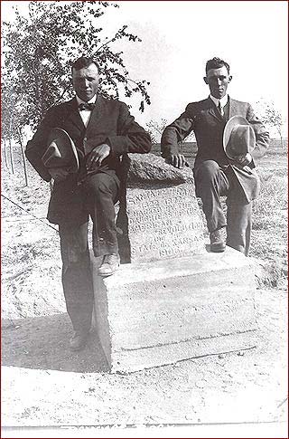 Two men pose next to the DAR monument, most likely after it was dedicated in May 1912. Many elms were planted along the road to the park not long before the dedication. This photo was found in a batch taken around 1914, according to Don Ross.