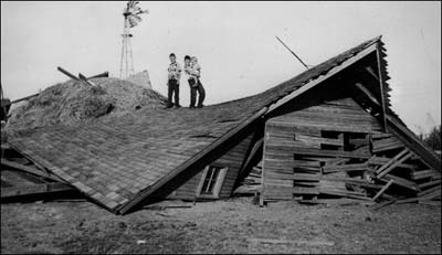 Bob, Larry, and Barb Schmidt atop the family's barn after it was destroyed by a tornado in 1952. Photo copyright 1952 by Paul Schmidt.