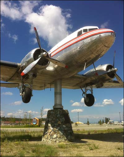 A DC-3 cargo plane that has been turned into a wind vane at the Whitehorse airport. I thought it was just a tourist gimmick until the wind turned dramatically and the plane's nose swung into it. Photo copyright 2011 by Leon Unruh.